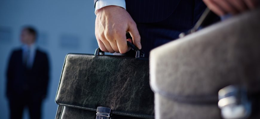 close up workers with briefcases