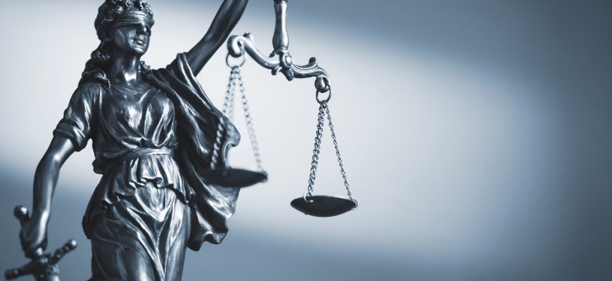 figure justice holding scales sword